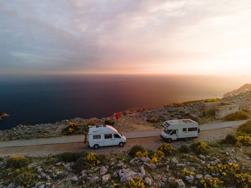 Two Camper standing on mountain in front of the ocean in Dubrovnik, Croatia. May, 2021.